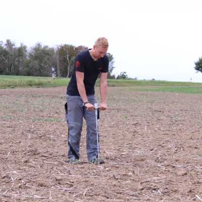 Farmer with soil compaction tester